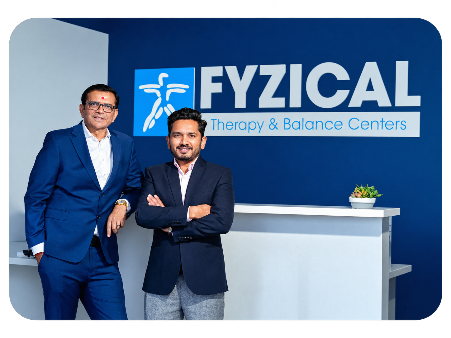 Entrepreneur Jignesh Domadia and Physical Therapist Jiten Dungarani standing in front of a FYZICAL sign.