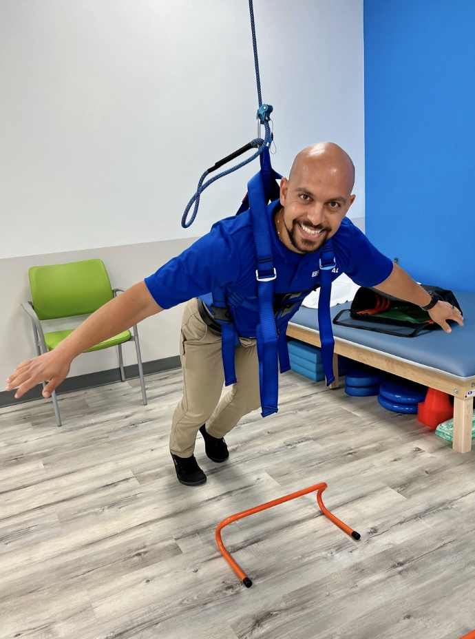 Dr. Amir Hakim with FYZICAL's Safety-Overhead-Support (SOS) System